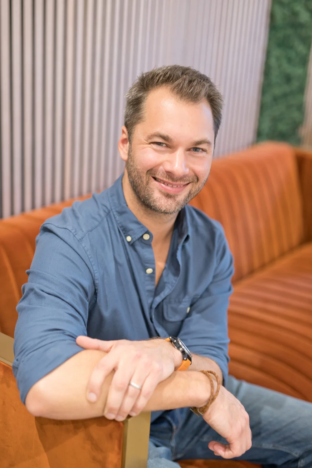 Chris Finn, CBT psychotherapist and life coach, seated in an armchair